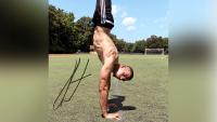 Fit male athlete performing a hand-stand
